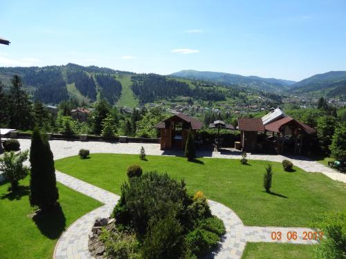 a view of a garden with mountains in the background at Alpenhof Pansion in Slavske