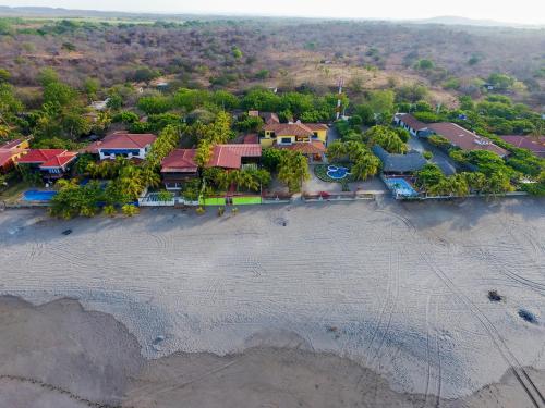 an aerial view of a resort on the beach at Solyar Luxury Spanish Beachfront Home in Pochomil