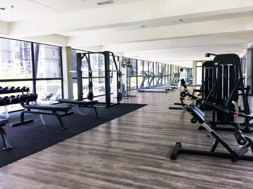 a gym with rows of treadmills and machines at Cozy Hyve Soho Suites in Cyberjaya