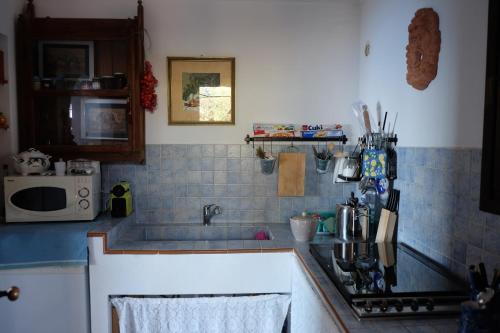 a kitchen with a sink and a counter top at Dammuso Il Sogno in Scauri
