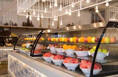 a buffet line with bowls of fruit on display at Ramada Plaza Antalya in Antalya