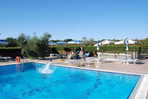 a pool with a person in the water at Antico Podere San Francesco in Vada