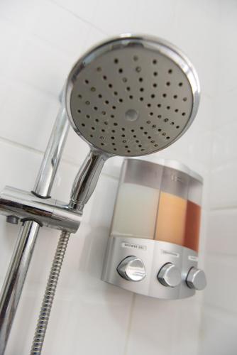a bathroom sink with a chrome shower head at The Lush in Willemstad