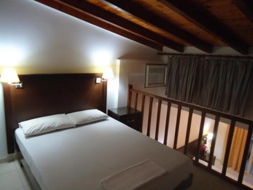 a bedroom with a large white bed in a room at Hotel Zachos in Troulos