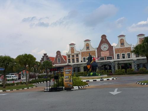 a large building with a chicken statue in front of it at D Savoy Famosa Condo in Melaka