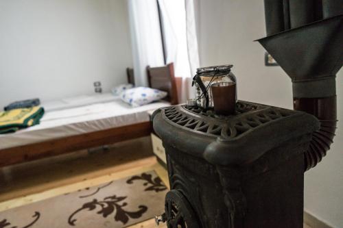 a room with a bed and a table with a blender at Eco Garten Guest House in Shkodër