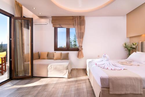 a hotel room with two beds and a window at Studios Apartments Irini Patira in Potos