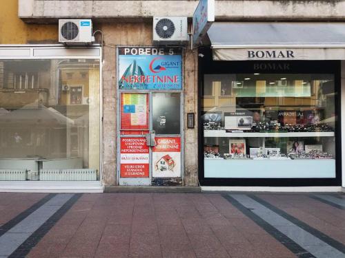 a store front of a building with windows at Square Studio Apartment in Niš