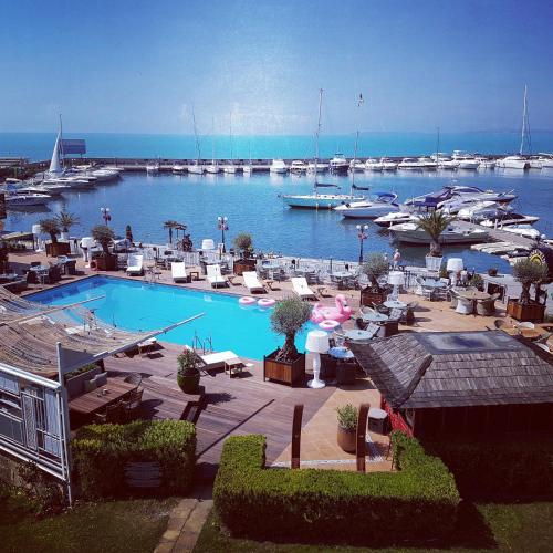 a large swimming pool with boats in a marina at Hotel Palace Marina Dinevi in Sveti Vlas