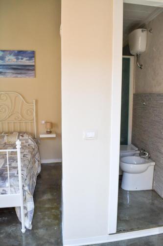 a bedroom with a bed and a sink and a toilet at B&B Vistamar in San Nicola Arcella