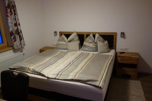a bedroom with a bed with pillows on it at Gasthof Dietrichshorn in Unken