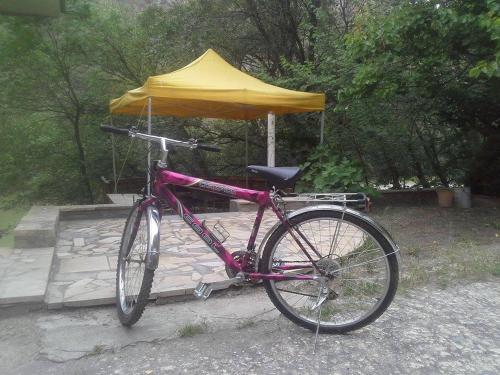 a bike parked in front of a yellow umbrella at Park-Hotel Khoren's Lake in Areni