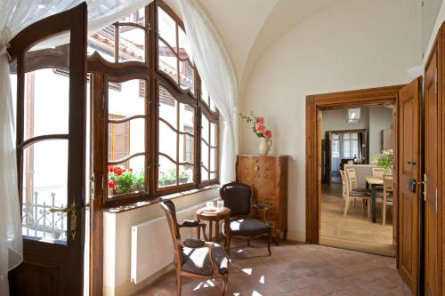 a hallway with a door and a table and chairs at Residence U Mecenáše in Prague