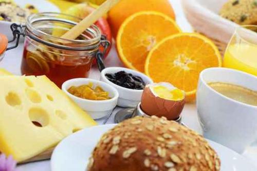 a table topped with eggs cheese and other foods at Kreuz-Post Hotel-Restaurant-SPA in Vogtsburg