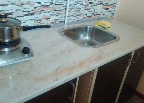 a kitchen counter with a sink and a stove at Fenix Rooms in Arbanasi
