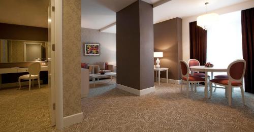 a room with a table and chairs and a dining room at Qafqaz Baku City Hotel & Residences in Baku
