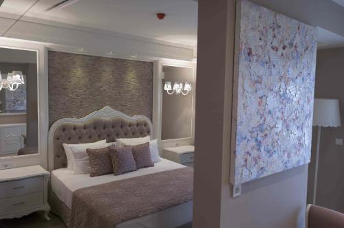 a bedroom with a large bed and a window at Ena Boutique Hotel & Residences in Bodrum City
