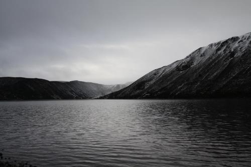 a black and white photo of a lake with mountains at Ballater Hostel in Ballater