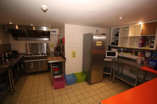 a large kitchen with stainless steel appliances and counters at Ballater Hostel in Ballater