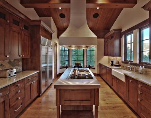 a large kitchen with wooden cabinets and a large island at Lodge at Vail, A RockResort in Vail