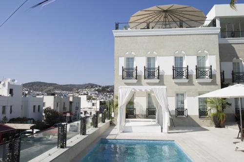 a view of a building with a swimming pool at Ena Boutique Hotel in Bodrum City