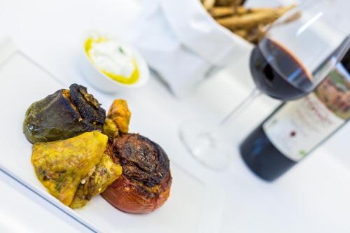 a plate with some food on a white table at Mikro Livadi Special Lodges - Has an Eco Salt water pool - 150m from the beach in Episkopí- Rethimno
