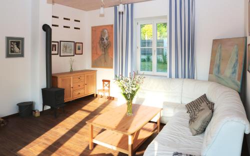a living room with a white couch and a table at Rekreační vilka Zlenice in Zlenice 