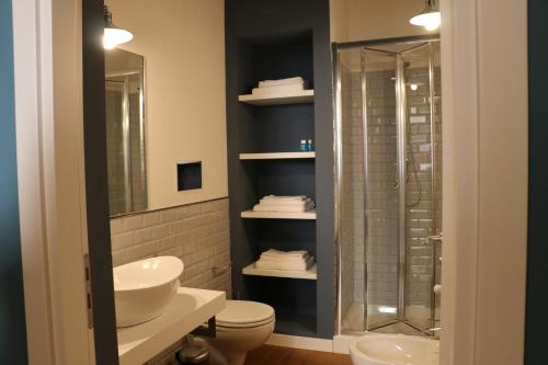 a bathroom with a toilet and a sink and a shower at La Terrazza di Carolina in Agrigento
