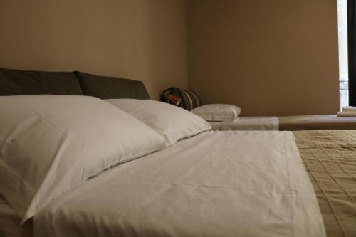 a white bed in a room with a window at La Terrazza di Carolina in Agrigento