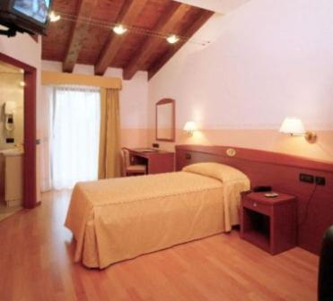 A bed or beds in a room at Hotel Ristorante Pedrocchi