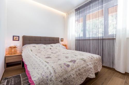 En eller flere senge i et værelse på Beach House Villa - Ap. 2