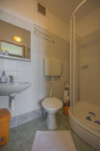 a bathroom with a toilet and a sink and a shower at Guest House Djurdjica in Dramalj