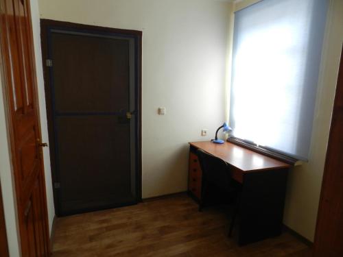 a room with a black door and a wooden desk at Dom on the seaside in Zatoka
