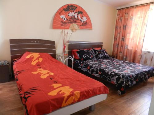a bedroom with two beds and a window and a bedskirts at Dom on the seaside in Zatoka