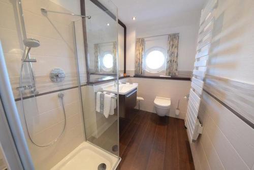 a bathroom with a shower and a sink and a toilet at Hiddensee in Wiek auf Rügen