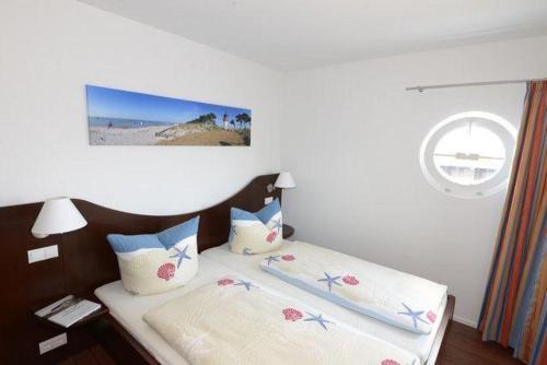 a bedroom with a bed with two pillows at Hiddensee in Wiek auf Rügen
