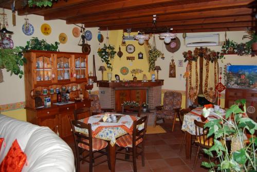 a dining room with a table and chairs and a fireplace at Sette Nani in Elmas