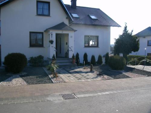 a white house with a door on a street at Haus-Irena in Longkamp