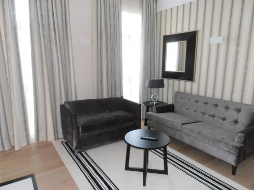 a living room with a couch and a chair at Gran Hotel Sardinero in Santander