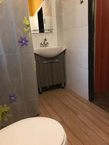a bathroom with a toilet and a sink at The White House by Casona Lo Aguirre - El Monte RM in Talagante
