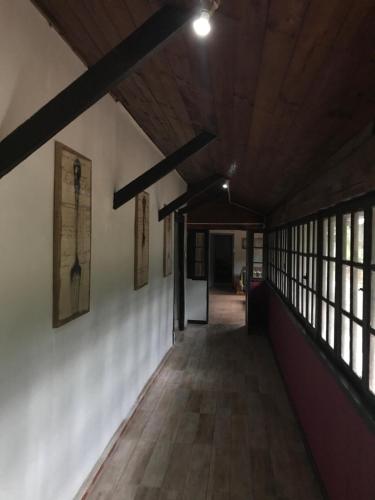an empty hallway in a building with windows at The White House by Casona Lo Aguirre - El Monte RM in Talagante
