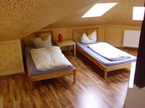 two beds in a room with a roof at 4R-Fewo-Altstadtblick-L15 in Dresden