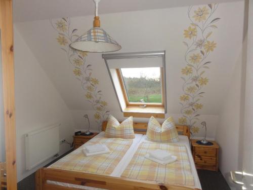 a small bedroom with a bed with a window at Fewo-Kroeger in Lancken-Granitz