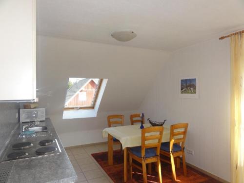 a kitchen with a table and chairs in a room at Fewo-Kroeger in Lancken-Granitz