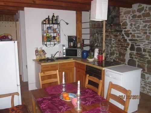 a kitchen with a table and a stove top oven at Ferienwohnungen-Willrich-Ferienwohnung-2 in Blankenheim