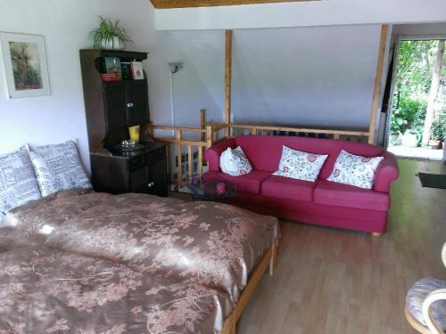a living room with a couch and a pink couch at Ferienwohnungen-Willrich-Ferienwohnung-3 in Blankenheim