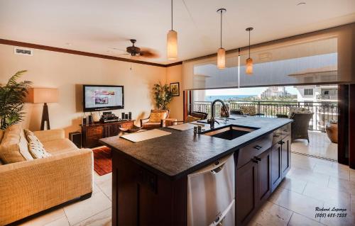 a kitchen with a sink and a living room at Beach Villas at Ko Olina 8th floor Ocean View in Kapolei