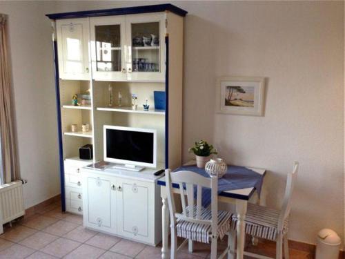 a dining room with a table with a tv and a table and chairs at Ferienwohnung-Meeresblick-Rerik in Rerik