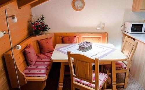 a small kitchen with a small table and chairs at Landhaus-Haid-Fewo-Alpenrose in Schönau am Königssee