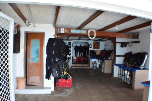 um quarto com garagem com roupas penduradas em Captngreggs Dive Resort em Puerto Galera